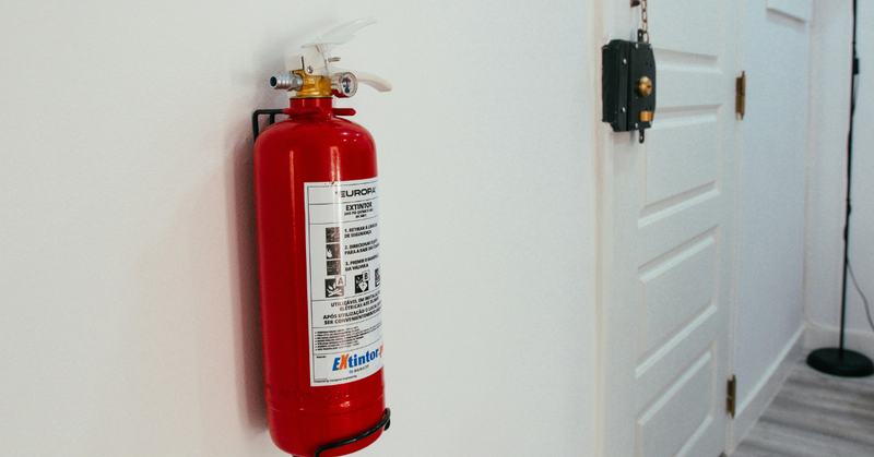 An image of a fire extinguisher mounted in an apartment.
